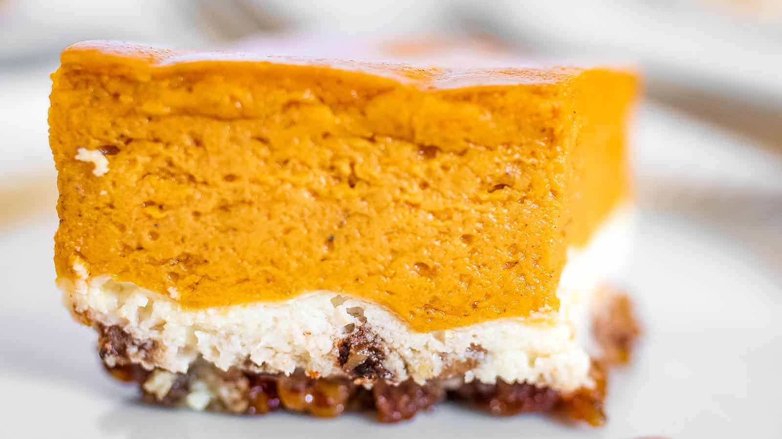 A slice of pumpkin cheesecake on a plate.