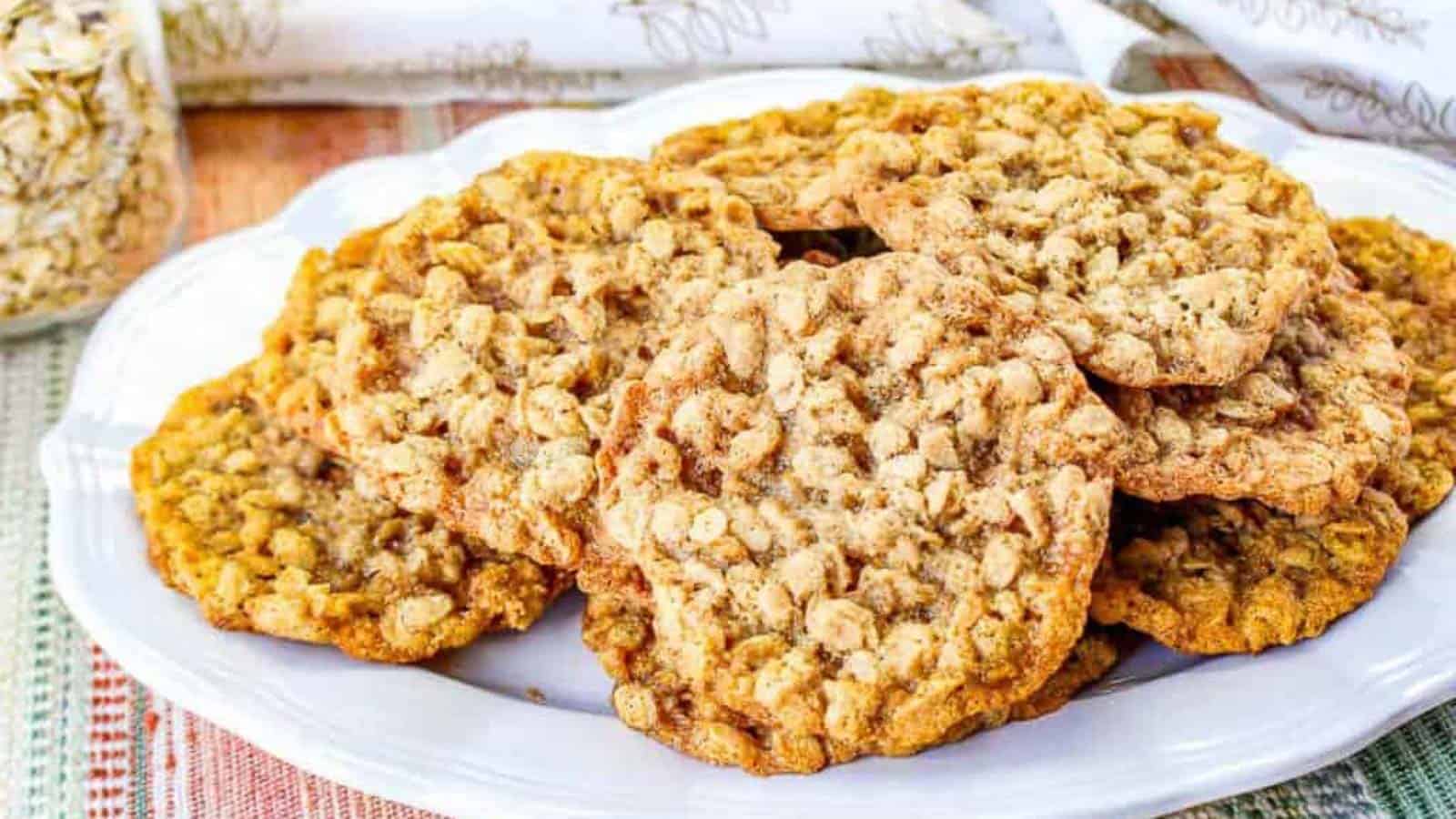 Low angle shot of oatmeal cookies on a white plate.