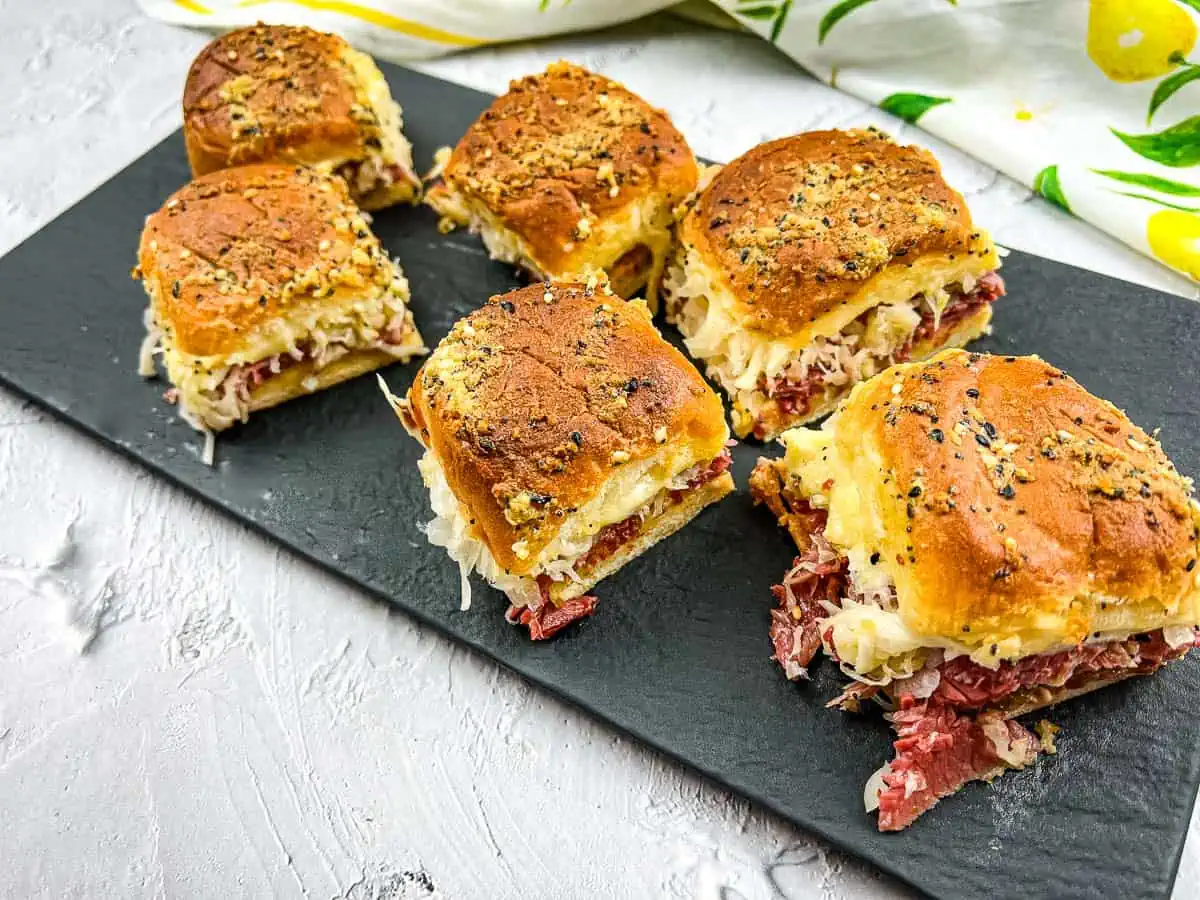 Reuben Sliders on a black platter.