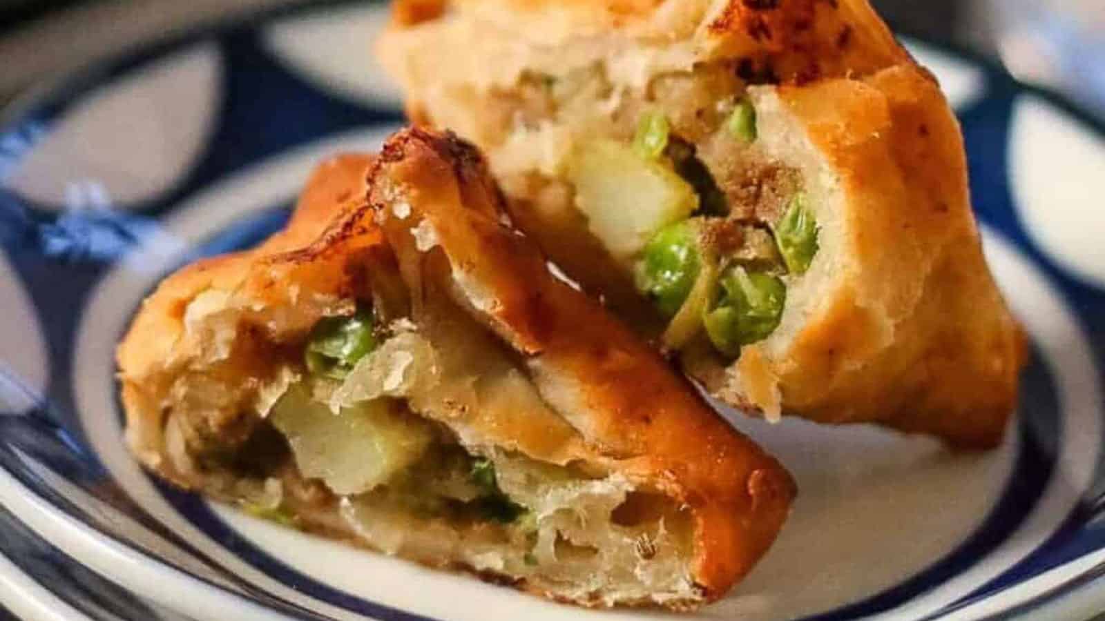 Fried dumplings on a blue and white plate.