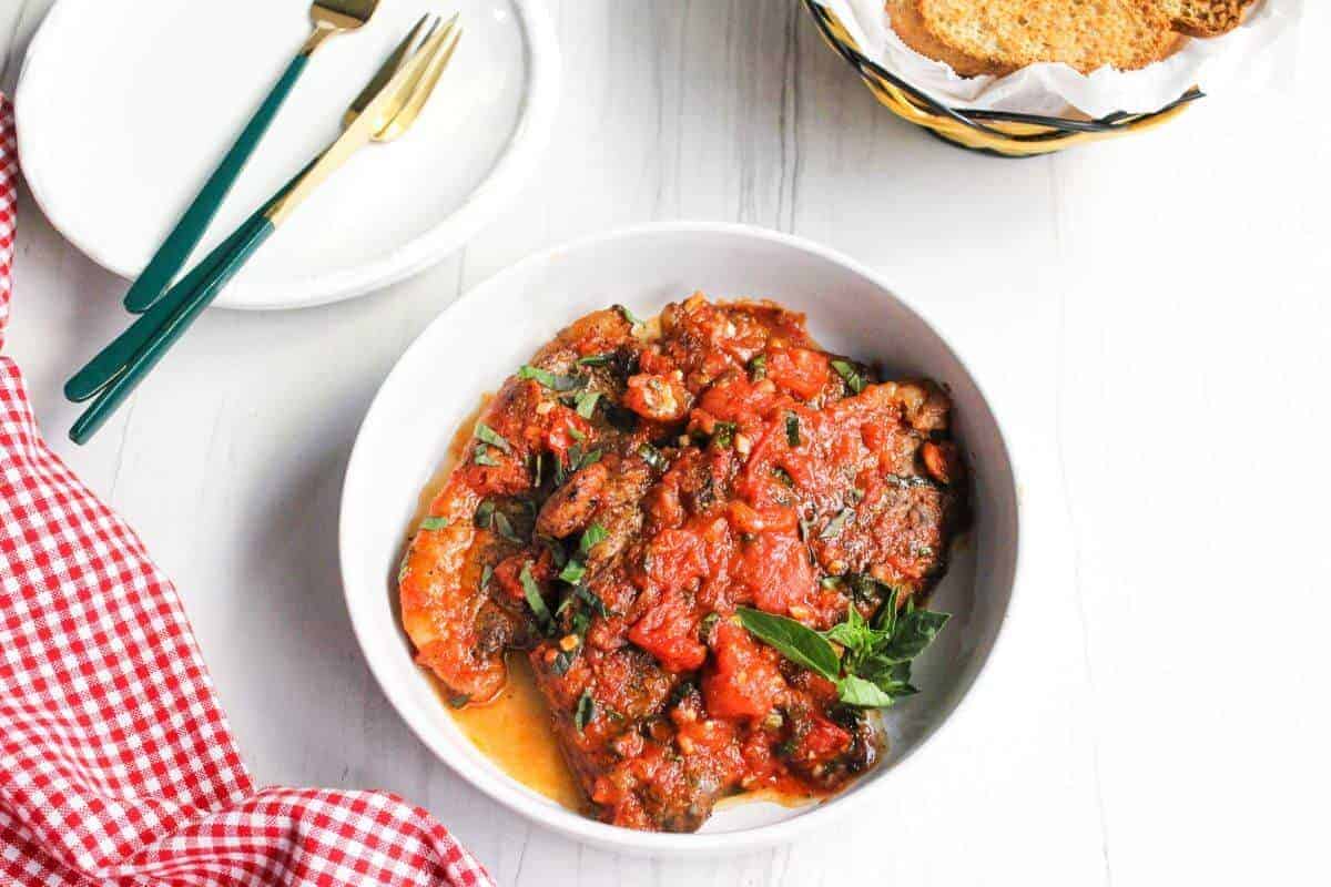 Serving of steak pizzaiola a bowl.