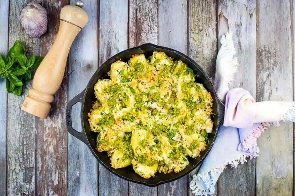 A closeup image of Turkey Stuffed Pasta Shells with Pesto in a baking dish.