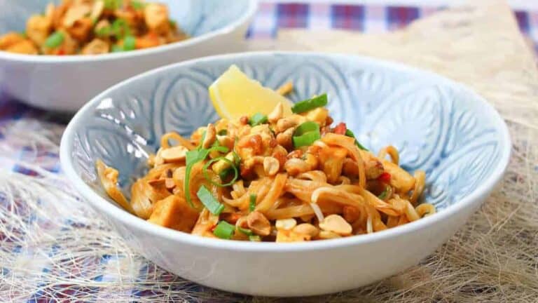 Low angle shot of a light blue bowl of pad thai.