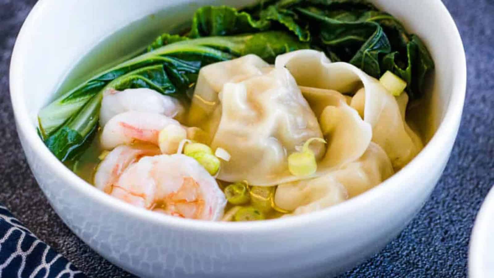 Low angle shot of a bowl of wonton soup.