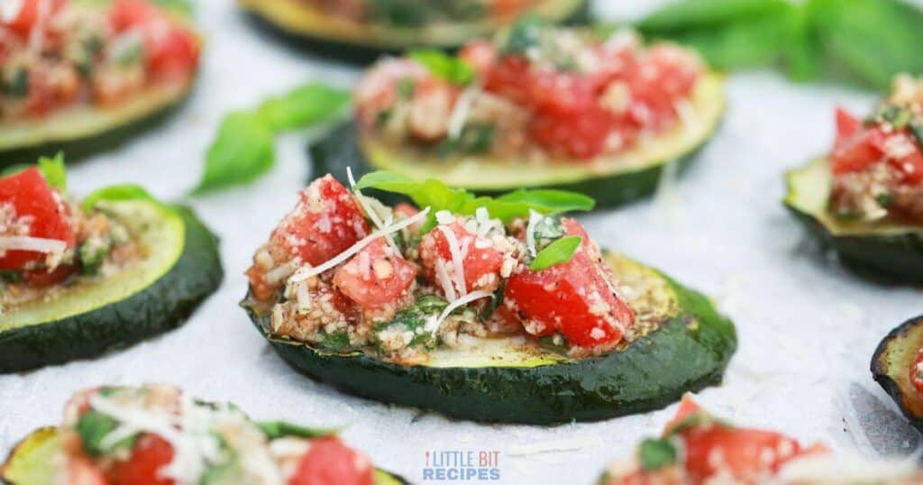 Stuffed zucchini boats with tomato and basil.