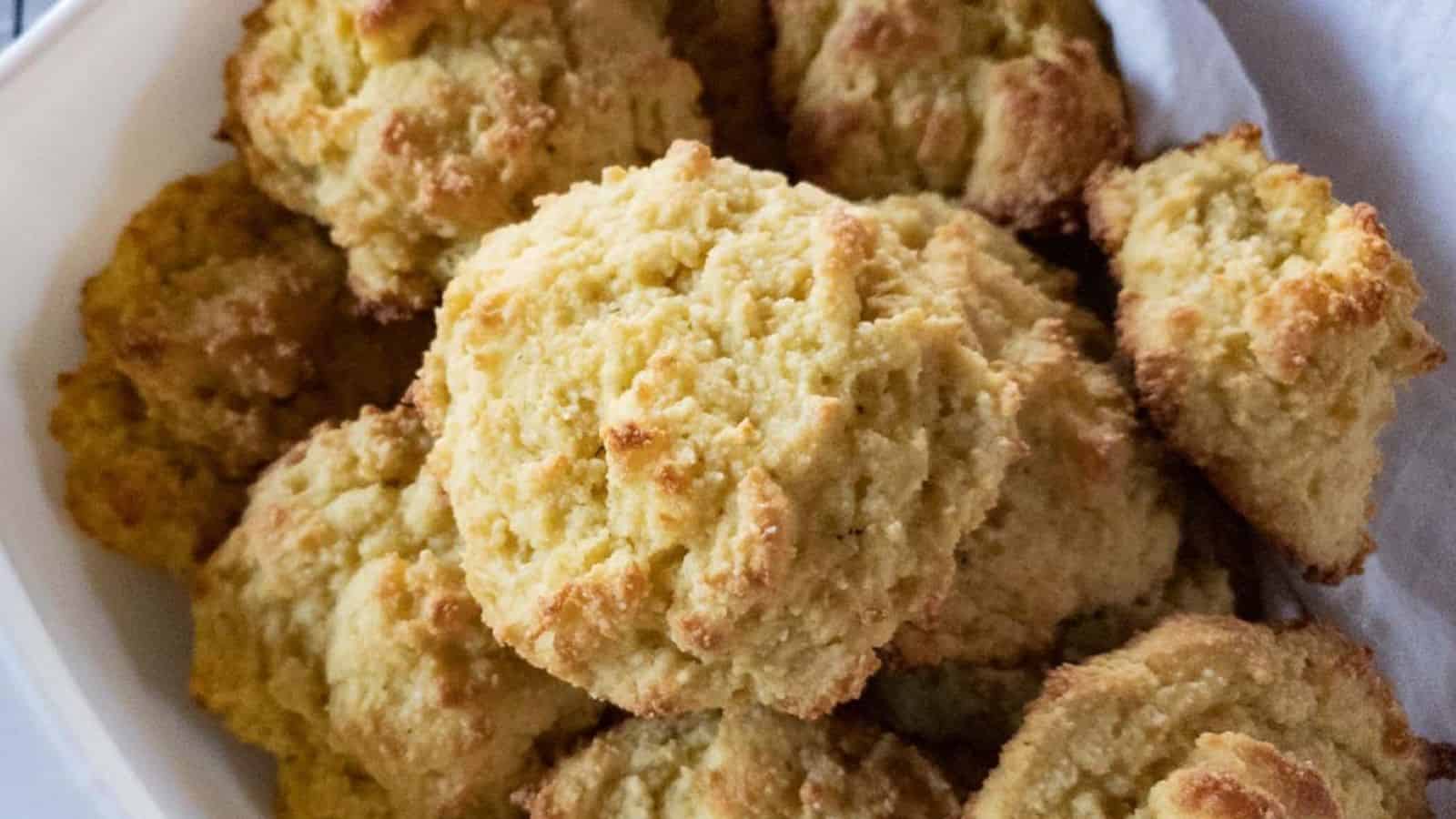 Buttermilk biscuits with almond flour in white dish on cooling rack.