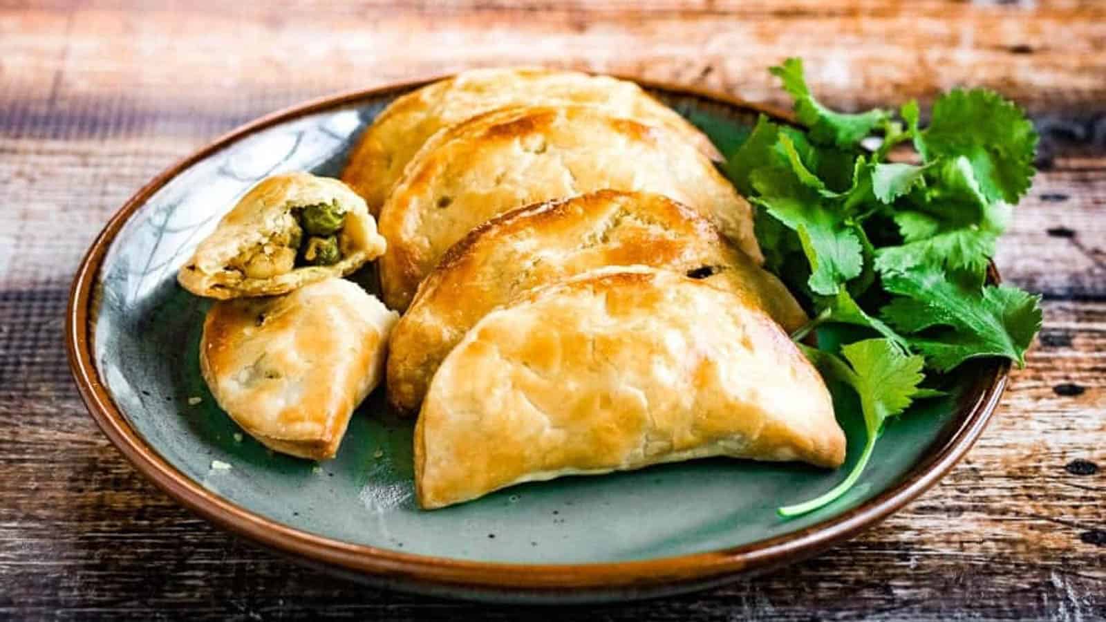 Thai curry puffs filled with ground chicken, potatoes, peas, onions, garlic and spices are a mouthwatering snack.