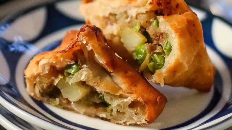 Fried dumplings on a blue and white plate.