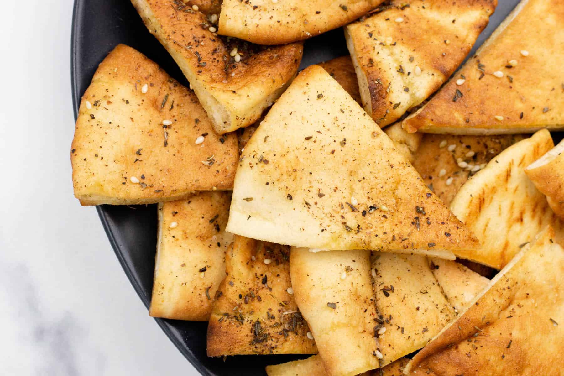 A plate of bread with herbs and spices on it.