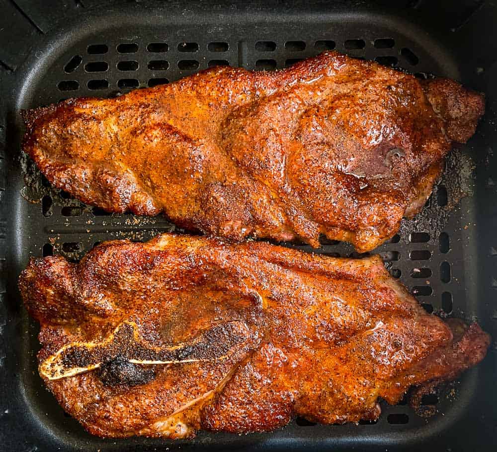 Air Fryer Pork Steak in the basket of an air fryer.