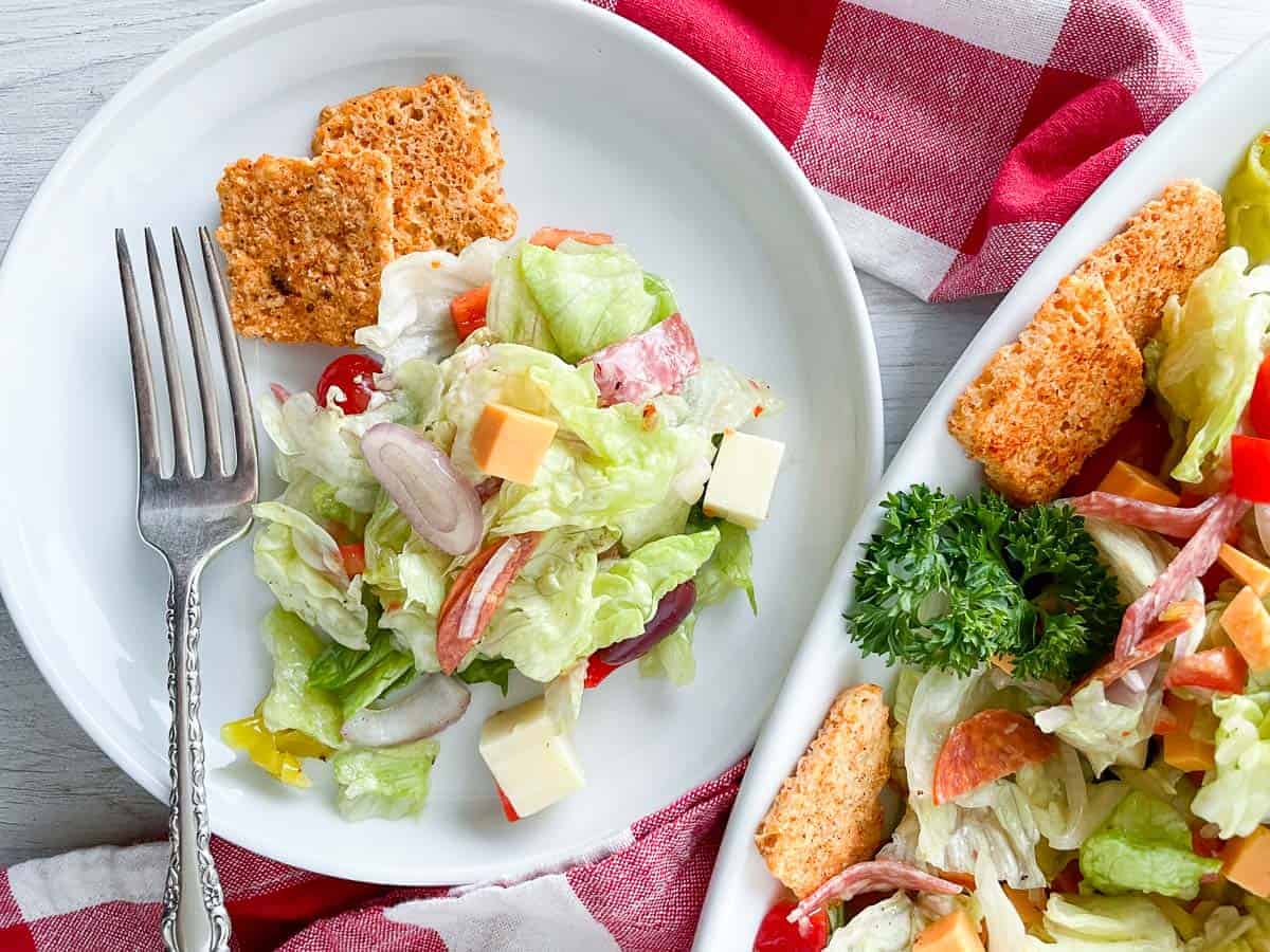 A platter of salad with croutons.