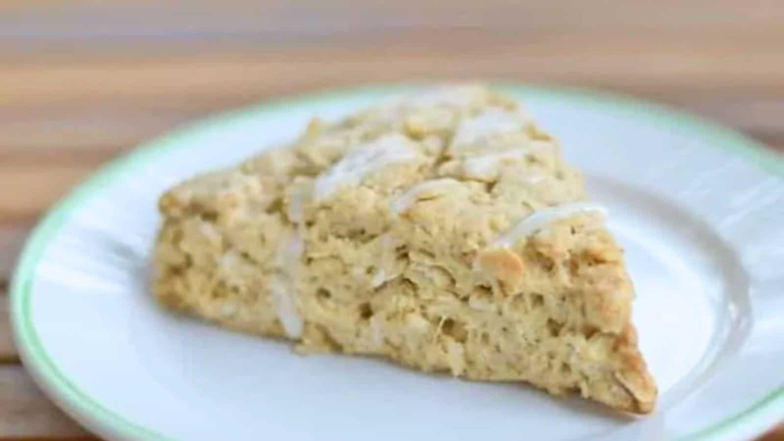 Image shows a Chai Scone on a white plate sitting on a wooden table.