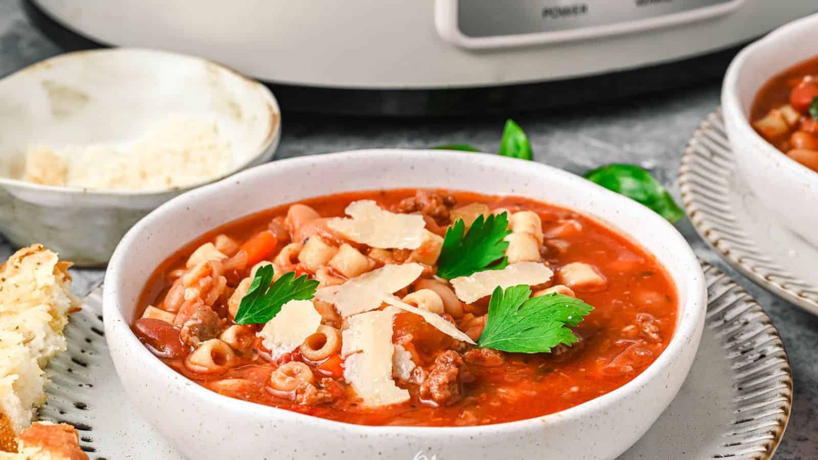 Two bowls of Copycat Pasta e Fagioli Soup in front of an instant pot.