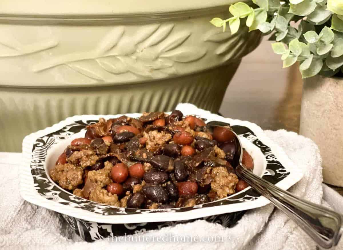 Crock pot cowboy beans in a white bowl.