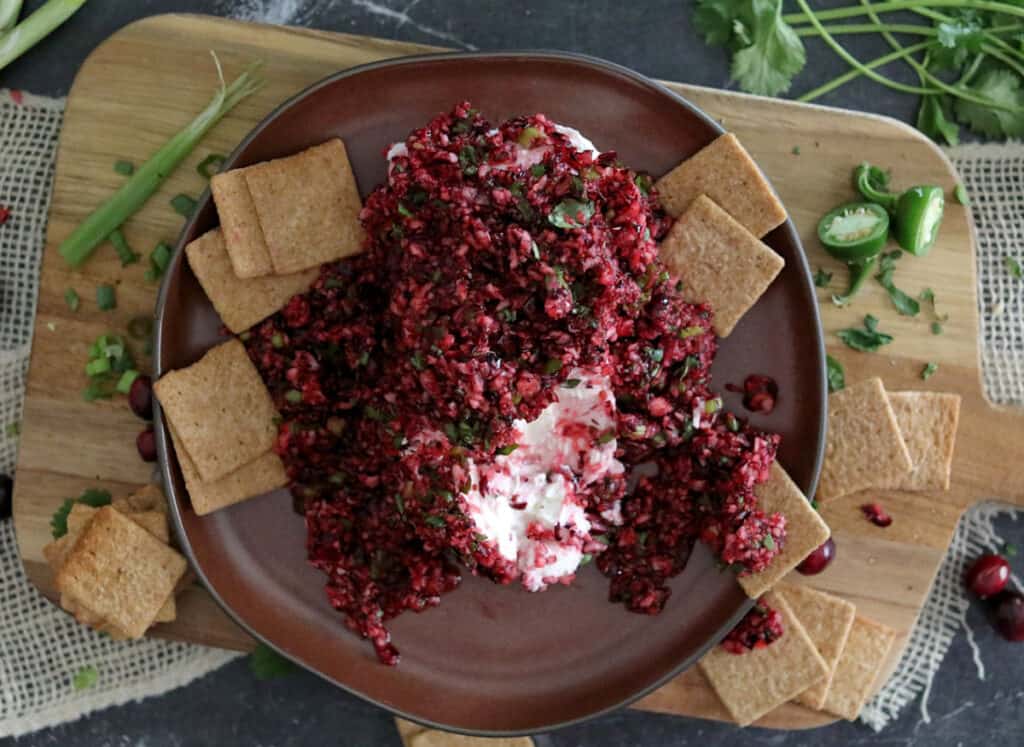 Cranberry dip with crackers on a plate.