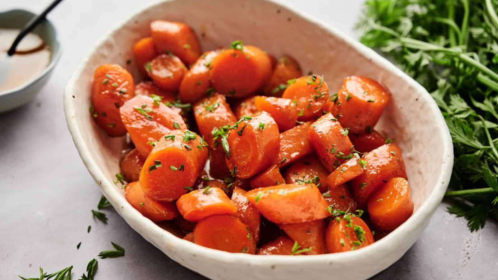 Air fryer glazed carrots in a bowl with parsley.