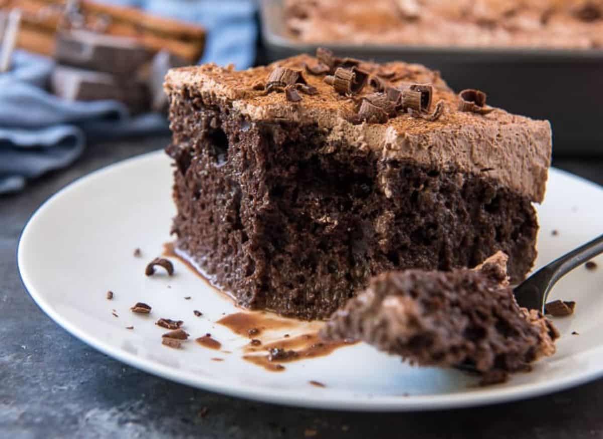 A slice of mexican chocolate tres leches cake on a plate.