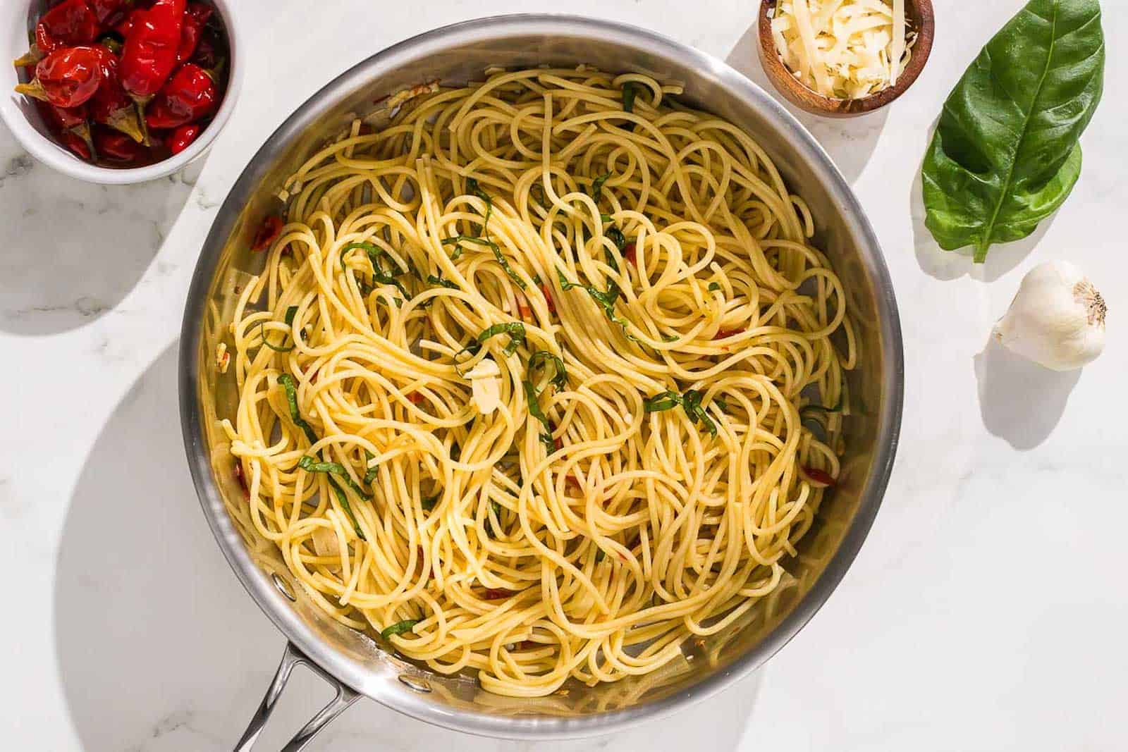 pasta aglio olio e peperoncino is mixed with a black pasta fork.