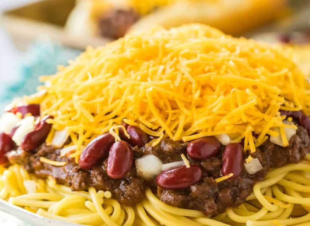 Cincinnatti chili on top of spaghetti and covered with cheese, beans and onions.