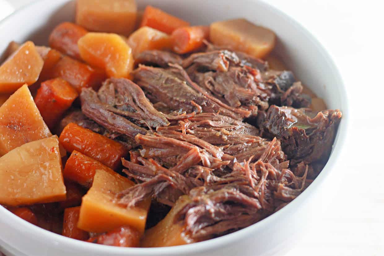 Roast beef, potatoes, and carrots in a bowl.