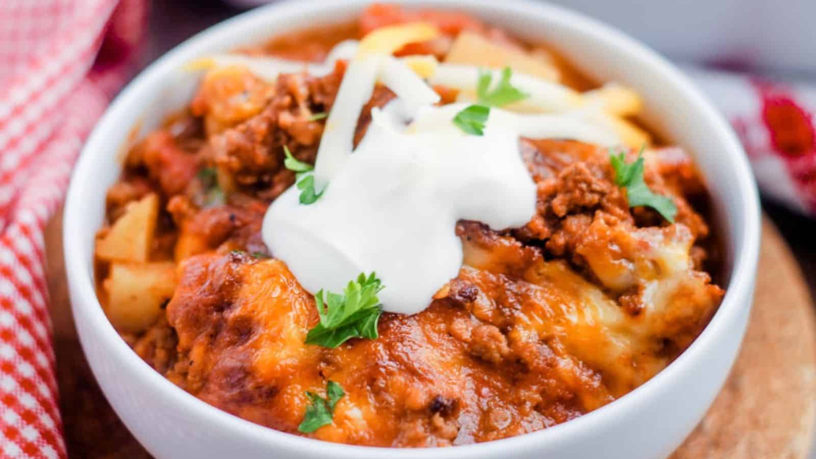 A bowl of Taco Potato Casserole topped with sour cream.