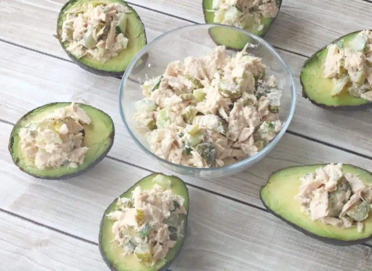 A plate with avocado and chocolate chip muffins on it.