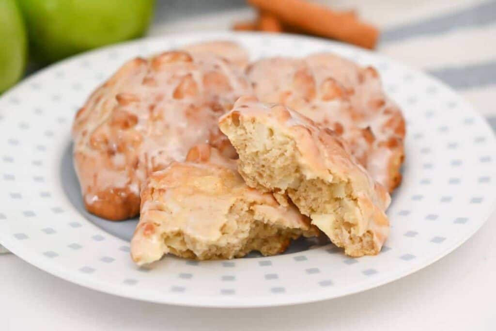 Apple cinnamon scones on a plate with cinnamon sticks.