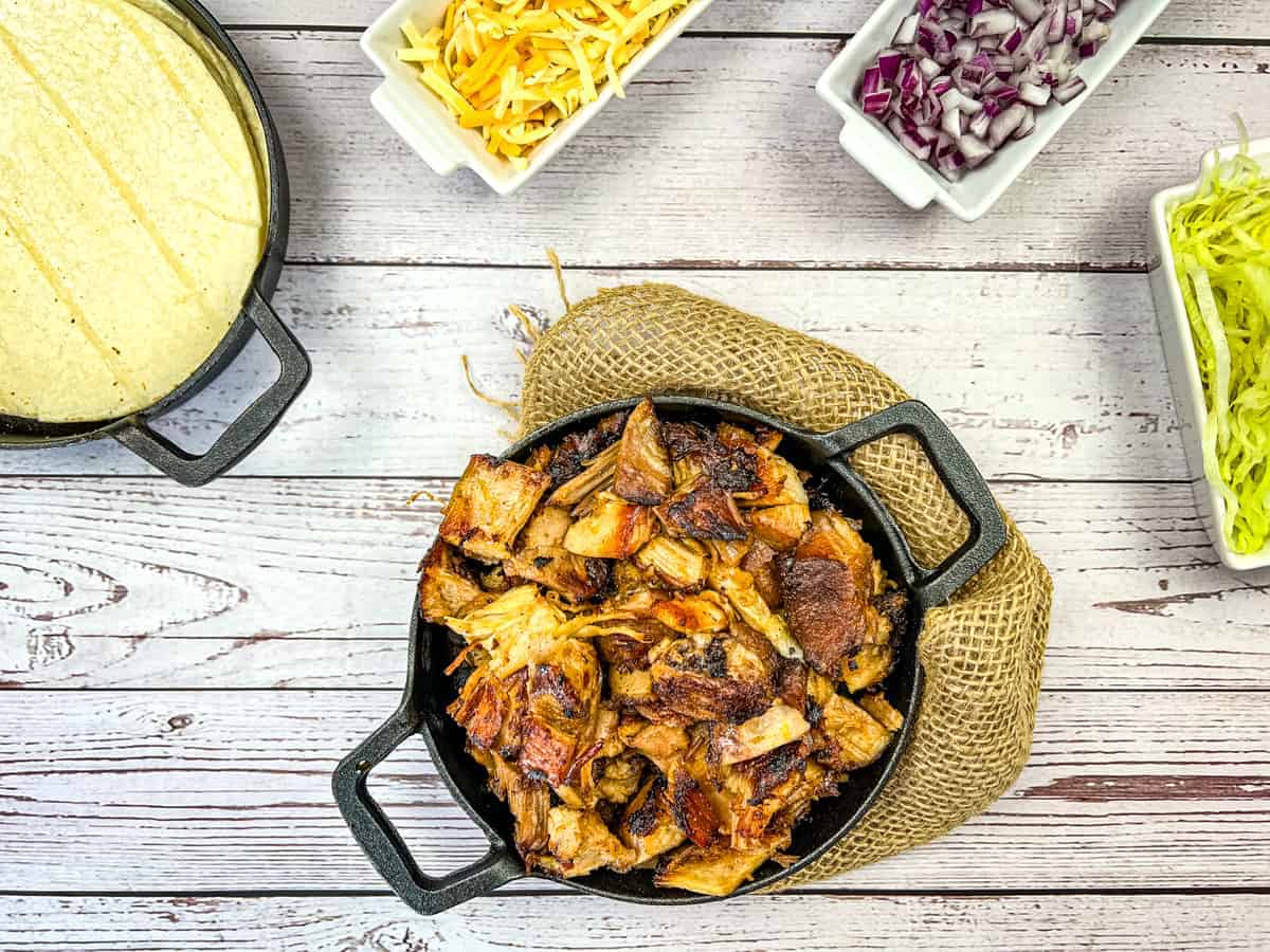 Carnitas in a round black dish.