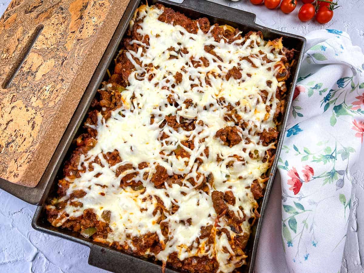 Spaghetti with meat and cheese in a baking dish