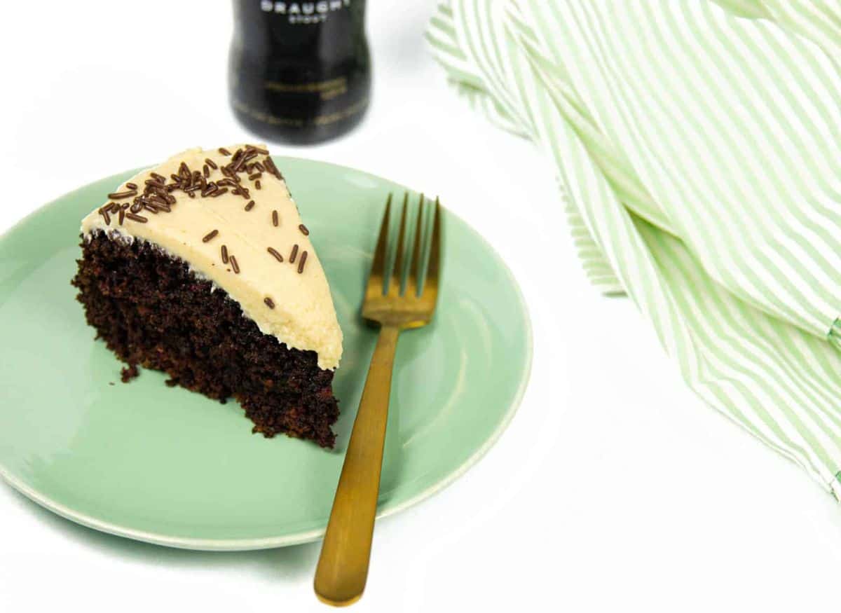 A slice of Guinness chocolate cake on a green plate.