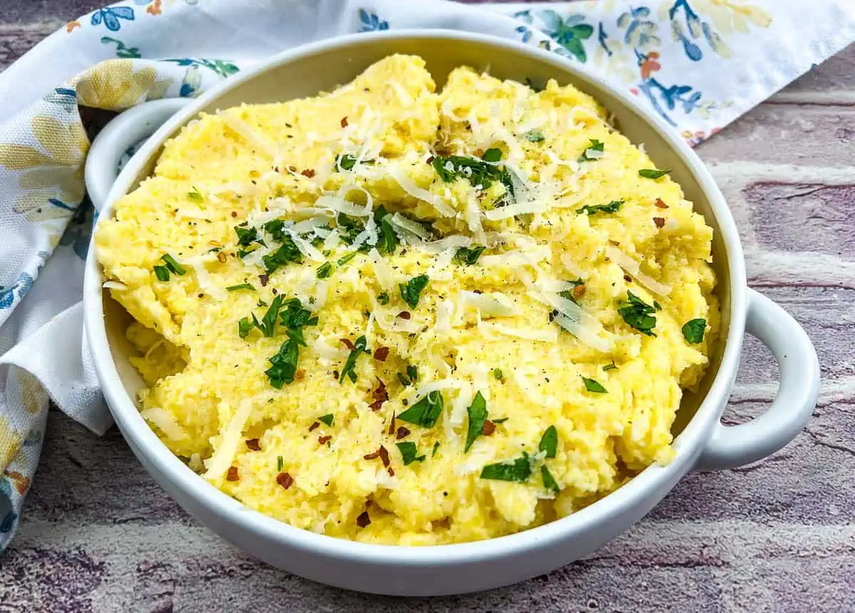 Polenta with mascarpone in a white bowl.