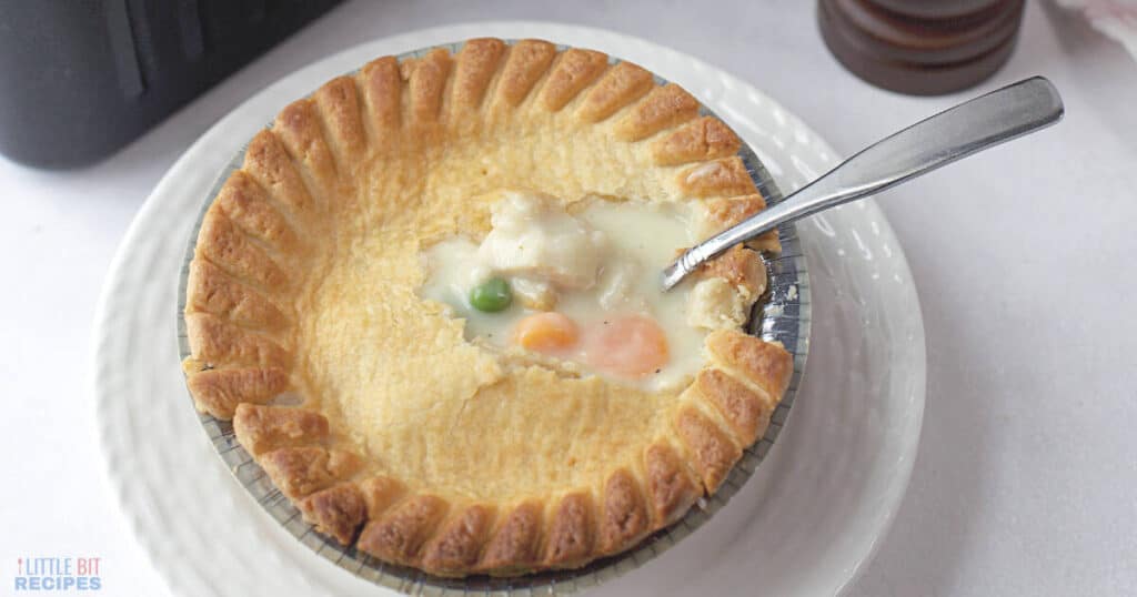 Small serving of chicken pot pie casserole on plate with fork.