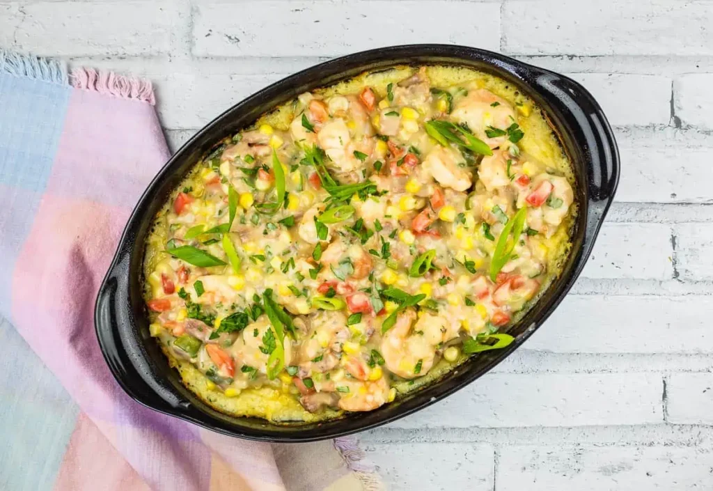 A black serving dish with Shrimp & Grits Casserole