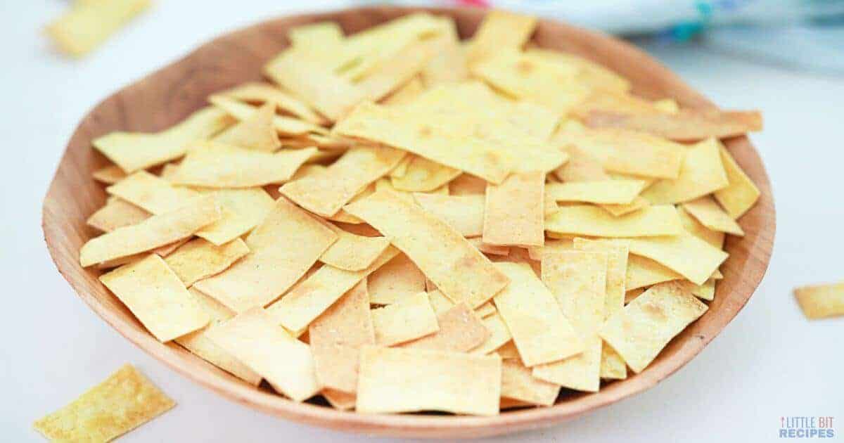 Tortilla strips in wooden bowl.