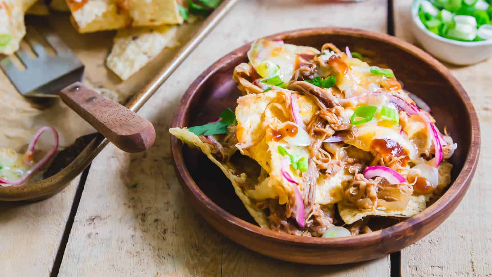 BBQ pulled pork nachos on a plate.