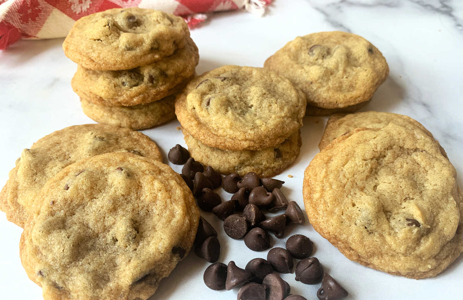 Chocolate chip cookies with chocolate chips on a marble board.