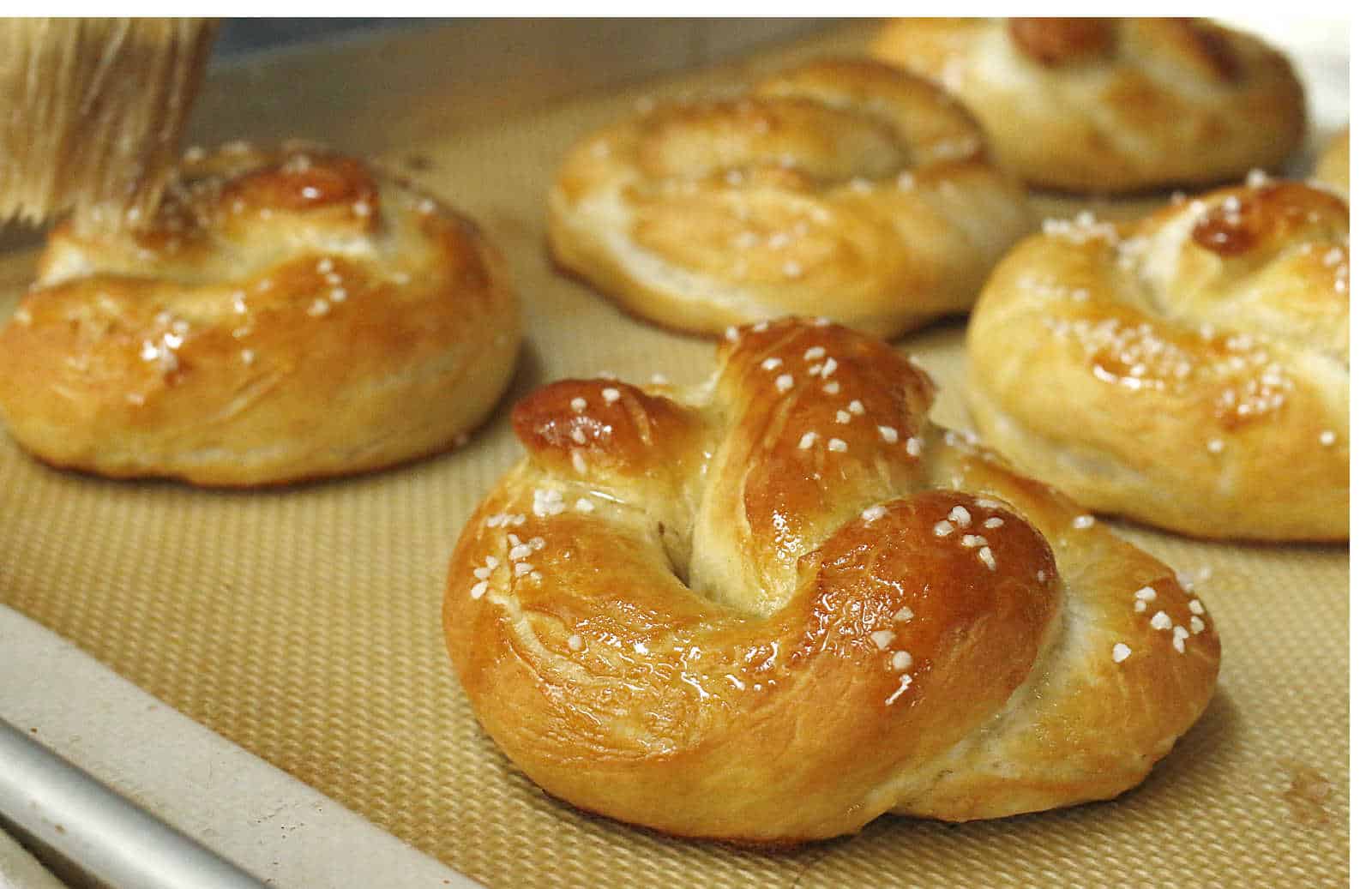 Baked pretzels on a baking sheet.