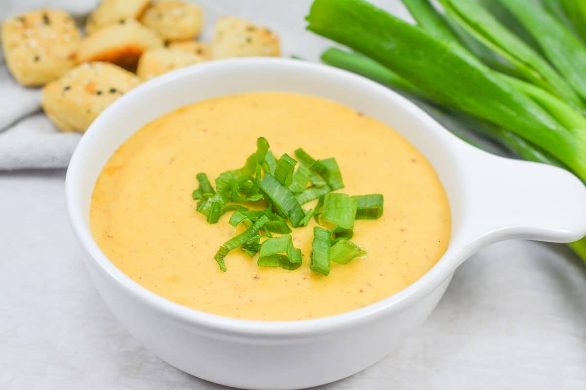 Cheese dip in a white bowl.