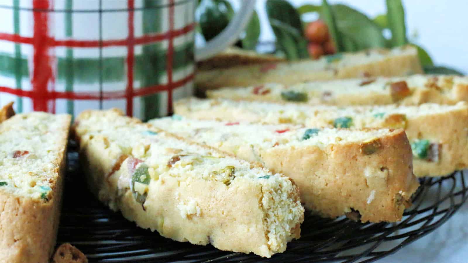 Candied fruit biscotti on a wire tray.