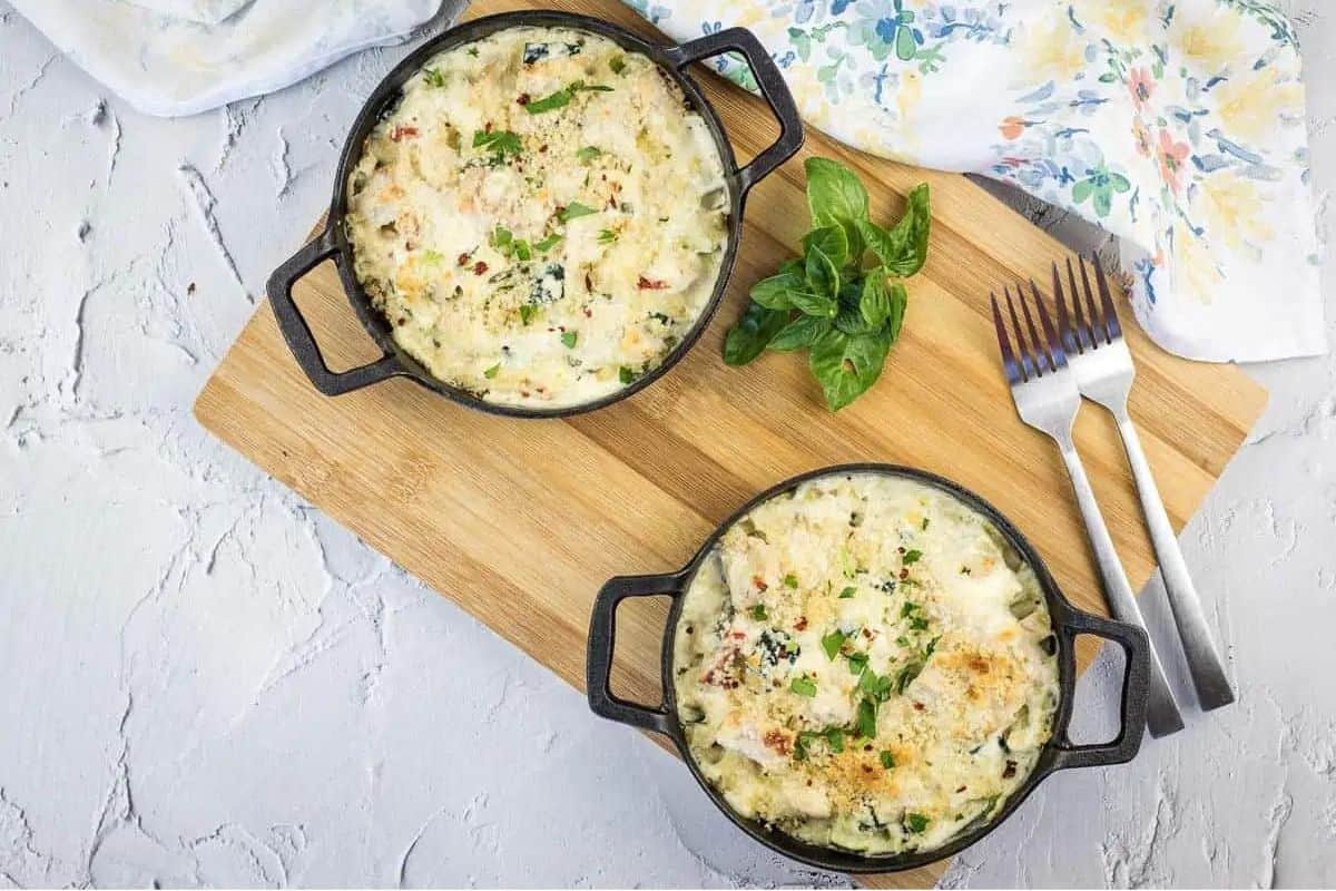 A chicken and zucchini disk in bowls on a cutting board.