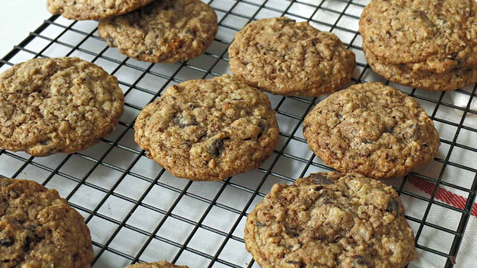 Chocolate oatmeal cookies on a wire rack.