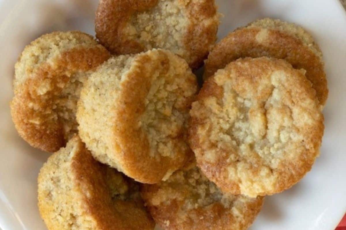 Crumb muffins on a white plate.