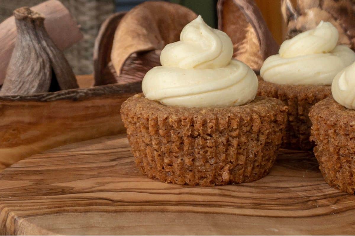 Muffins on a wood cutting board.