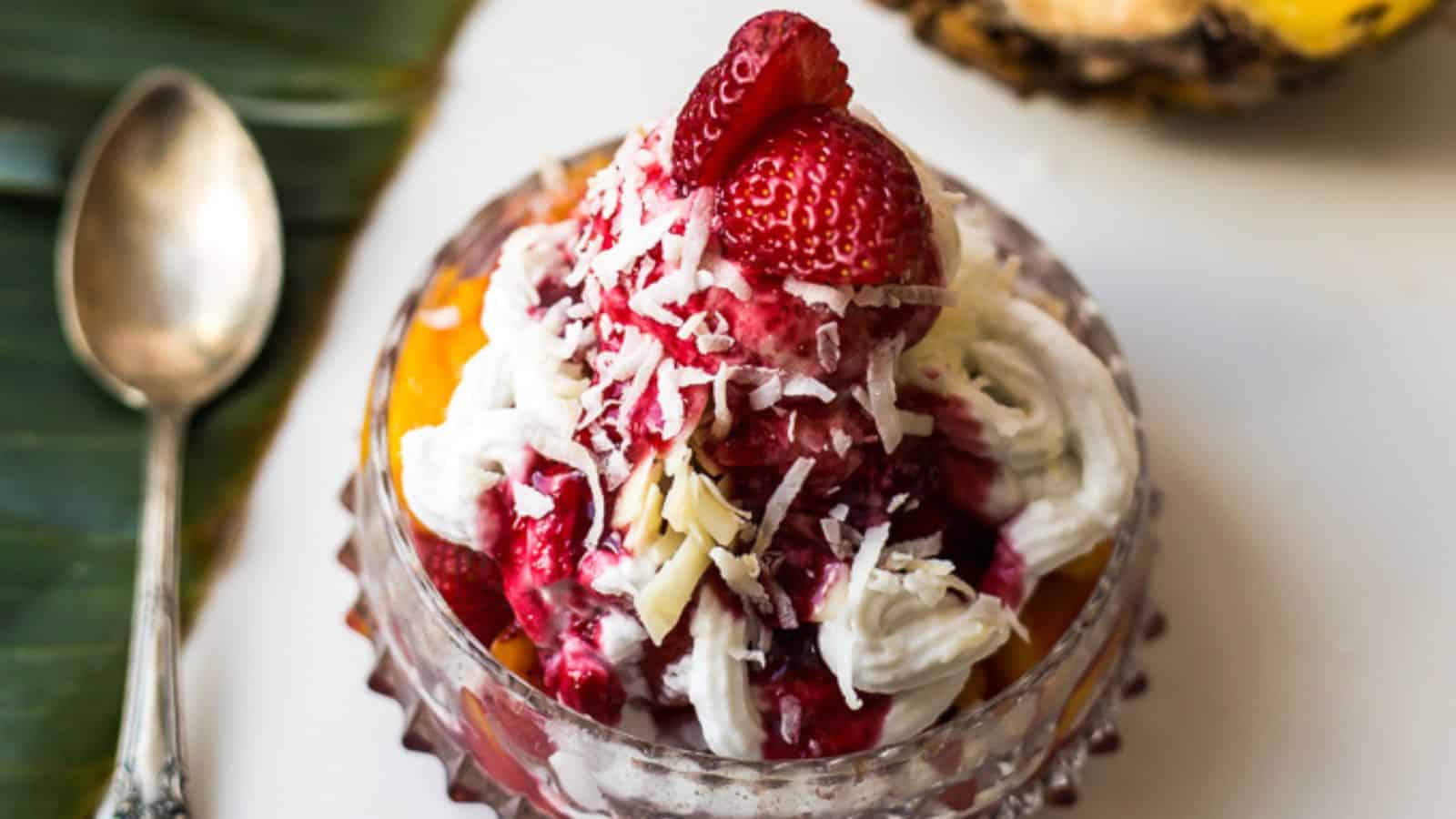 An easy breakfast dessert with whipped cream and strawberries on top of a pineapple.