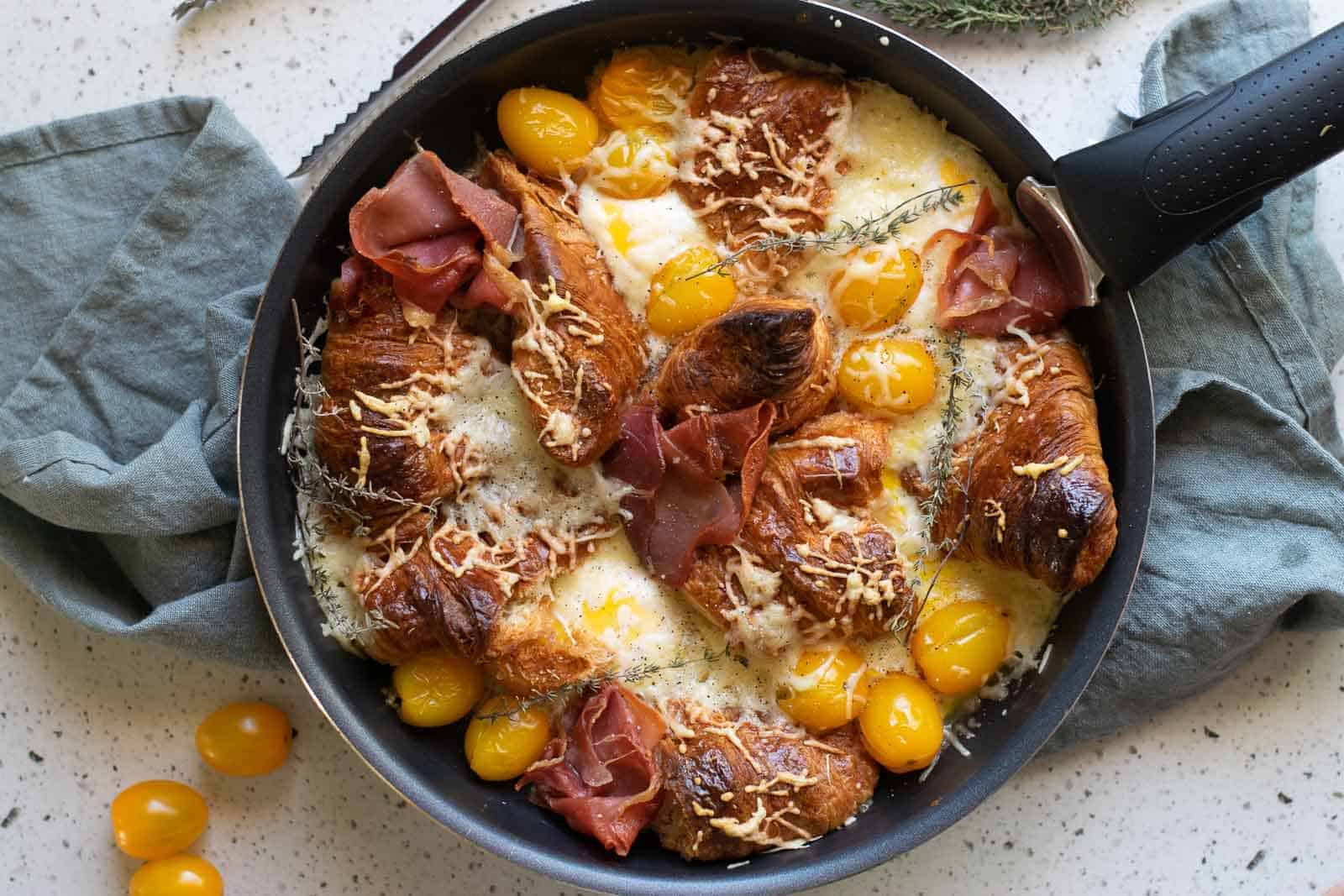 A cozy skillet filled with eggs, bacon and tomatoes.