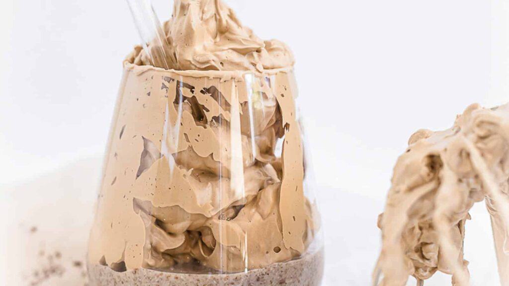 Easy chocolate ice cream in a glass with a spoon.