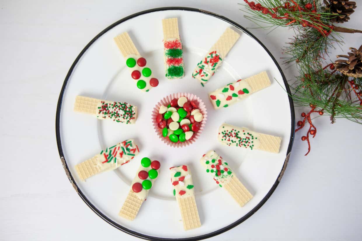 A plate with Christmas cookies and candy on it.