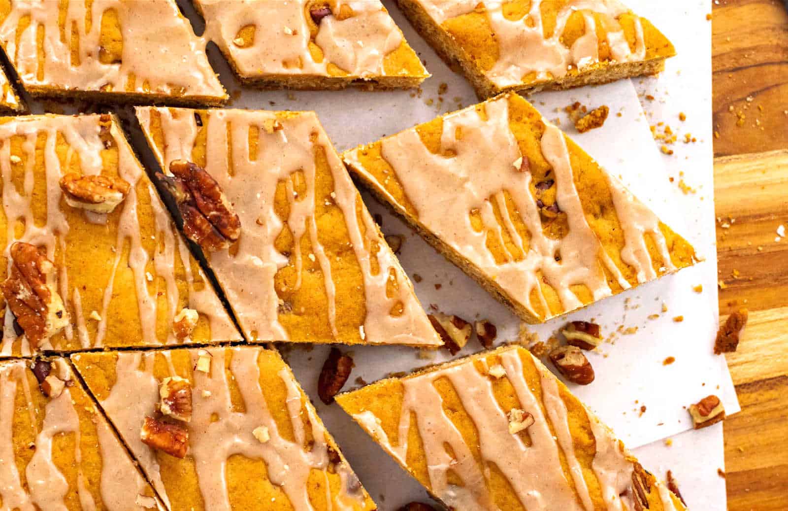 Pecan blondies on a brown cutting board.