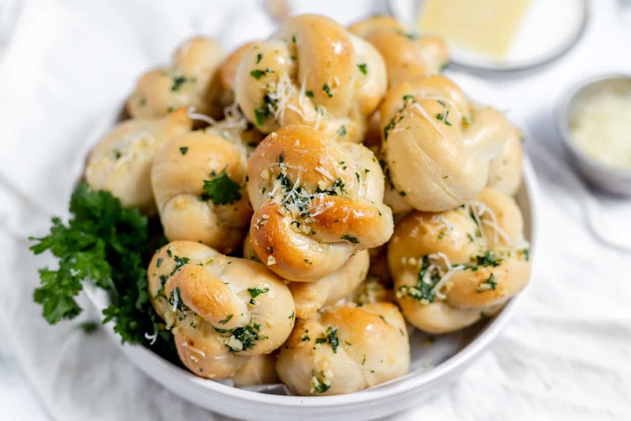 A pile of bread rolls on a plate.