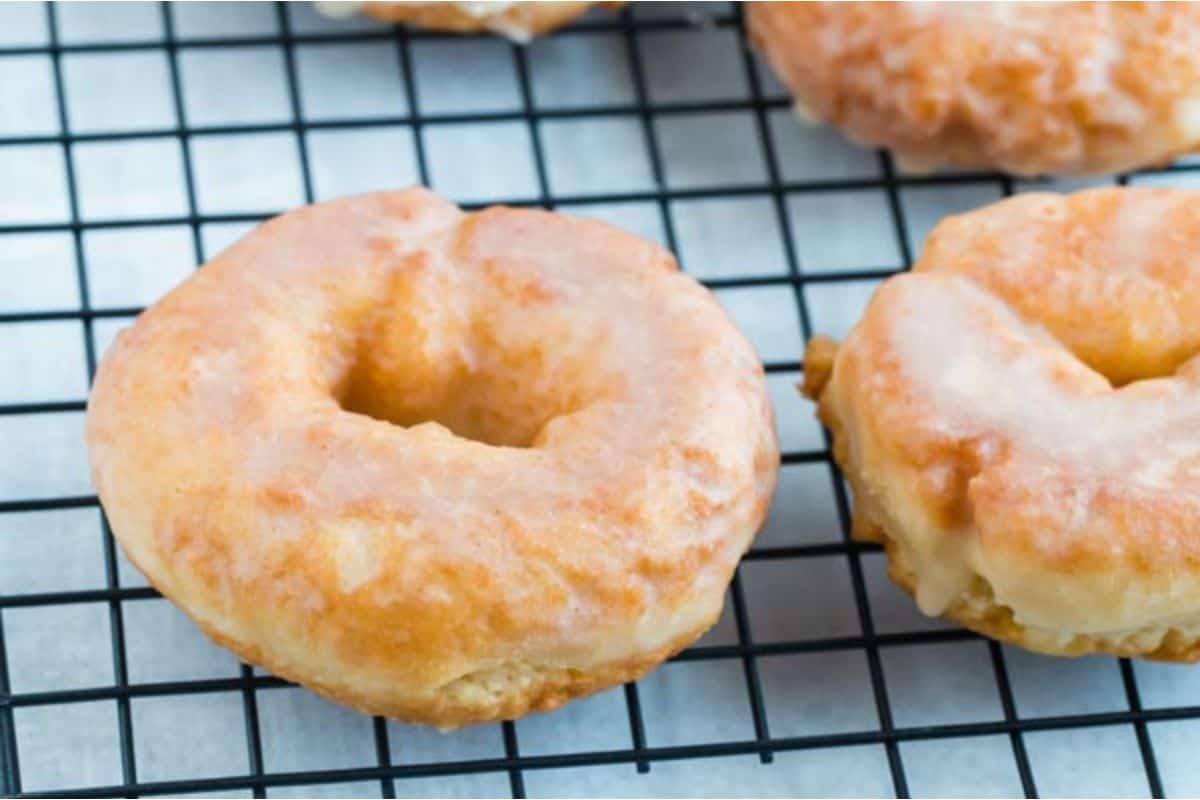 Glazed donuts on a cooling rack.